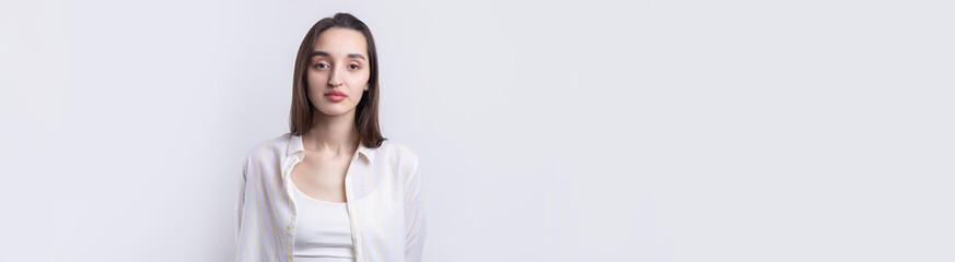 Obraz premium Portrait of a beautiful young woman thinking, isolated on white background