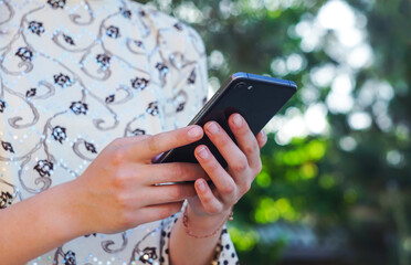 The girl has a phone in her hand