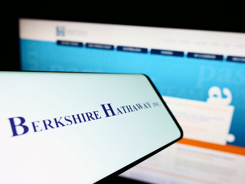 Stuttgart, Germany - 10-09-2022: Mobile phone with logo of US holding company Berkshire Hathaway Inc. on screen in front of website. Focus on center-right of phone display.