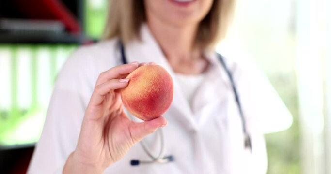 Nutritionist doctor holding peach fruits in his hands closeup 4k movie slow motion