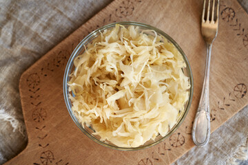 A bowl of homemade fermented cabbage or sauerkraut on a table