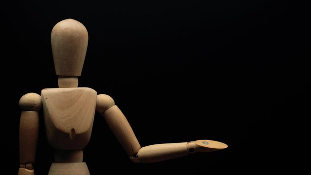 wood mannequin raises left hand. Stop motion animation.
