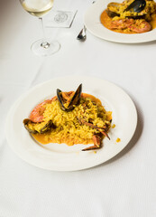 Traditional spanish seafood paella ready to eat at the restaurant table