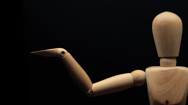 wood mannequin raises right hand. Stop motion animation.