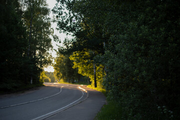 Turning road. Highway bending in rural areas. Empty road in summer.