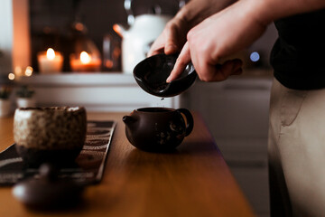 Young man prepares chinese pu-erh tea for the tea ceremony