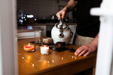 Young man prepares chinese pu-erh tea for the tea ceremony