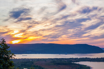 sunset on the Volga river. Natural landscape. reflection, blue sky and yellow sunlight. landscape during sunset.