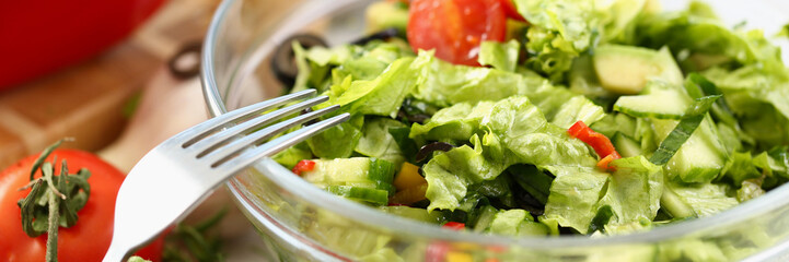 Delicious fresh greek salad with fresh lettuce leaves, tomato, cucumber, feta, olives, pepper