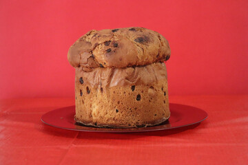 Panettone, typical Italian sweet at Christmas with red background