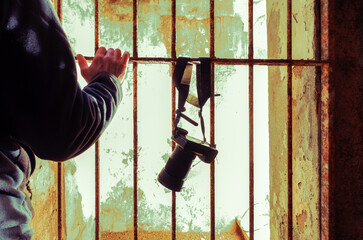 Man and camera locked up behind bars - Photo reporter  in a old rusty prison - Concept of denial of...