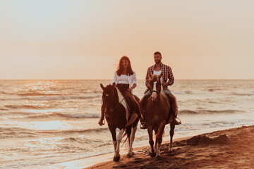 A loving couple in summer clothes riding a horse on a sandy beach at sunset. Sea and sunset in the...