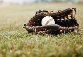Baseball, sport and ball with glove on a grass pitch or field outdoor for a competitive game or...