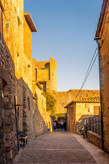 Fototapeta na wymiar Monteriggioni, Italy, 17 April 2022: historic center of the medieval town at sunset