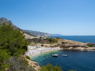Calanques, France, May 20th 2022: Beautiful bay with small sandy beach at a rocky coast