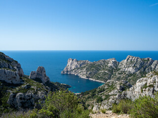 Fototapeta na wymiar Calanques, France - May 20th 2020: Hiking high above the Mediterranean Sea along a rocky coast