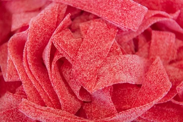 Crédence de cuisine en verre imprimé Bonbons Closeup of a heap of strawberry belts.