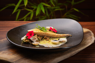 Grilled sea bass fillet with ginger sauce and clams / Fusion food - obrazy, fototapety, plakaty