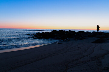 Blue hour on the beach with rocks in the water, long exposure