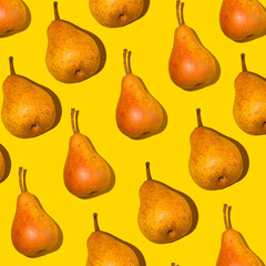 Colorful pear pattern. Orange Bera pears on a yellow background. Ripe juicy fruits with shadow top view. Food background. Creative concept.