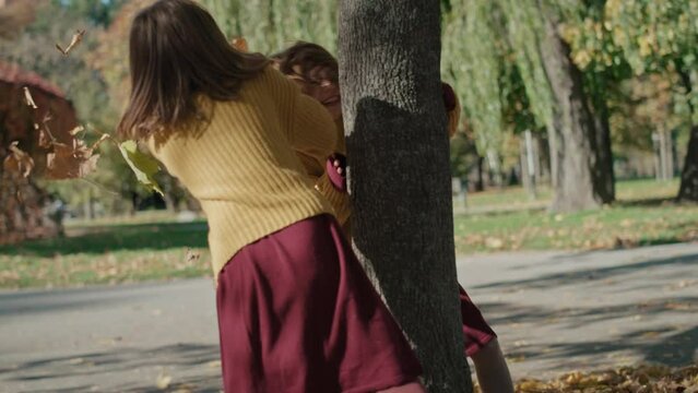04
Caucasian child siblings having fight with leaves in the autumn park. Shot with RED helium camera in 8K.   
