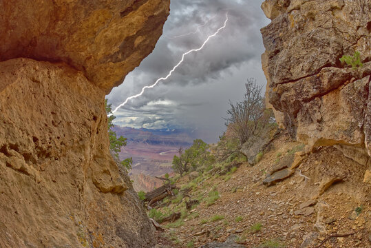 Grand Canyon viewed from inside a cave between Zuni and Papago Points while a storm is rolling into the area, Grand Canyon National Park, UNESCO World Heritage Site, Arizona
