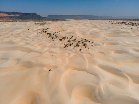 A stretch of white dunes surrounded by canyons near Kamour, Mauritania, Sahara Desert