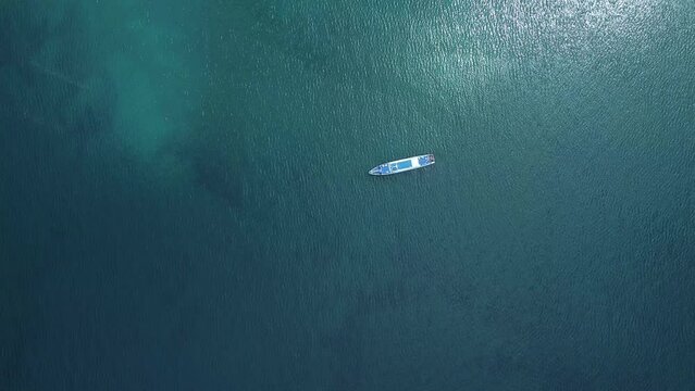 4k Beautiful aerial view of ship moves on sea outdoors irrl. Top of large transport moving quietly on turquoise water surface and traveling in open air in summer. Tourist captures unique scenery and