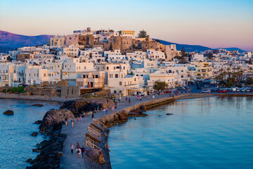 Dusk over Naxos town and causeway to The Porta Gateway, part of the unfinished Temple of Apollo, Naxos, the Cyclades, Aegean Sea, Greek Islands