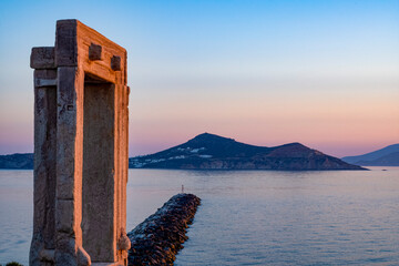 Dusk at Porta Gateway, part of the unfinished Temple of Apollo, Naxos Town, Naxos, the Cyclades, Aegean Sea, with Paros beyond, Greek Islands