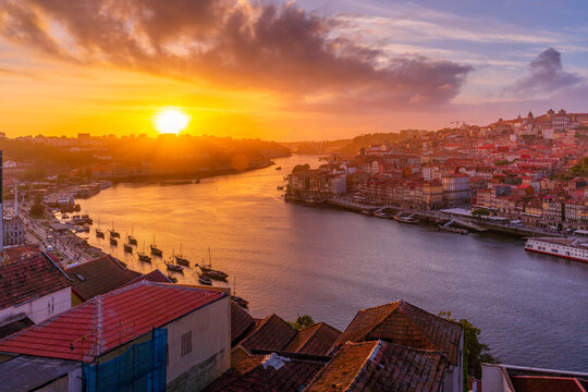 View of sunset over terracota rooftops and Douro River in the old town of Porto, Porto, Norte