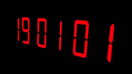 Digital timer on a black background. Light panel with red numbers