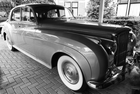 Den Ham, Netherlands - Sept 27 2022 A Bentley S1 with whitewall tires was parked. This car is produced from 1955 until 1959. The S1 was derived from the Rolls-Royce Silver Cloud. Black and white photo