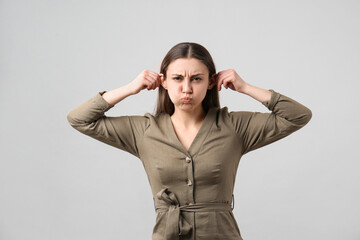 Young woman having fun on light grey background. Personality concept