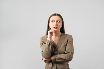 Portrait of young woman on light grey background. Personality concept