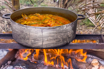 Cuisson extérieure au feu de bois, marmite de cari de poissons pour pique-nique créole 