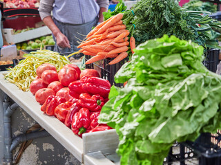 Selective focus on a bunch of carrots at a market stall. Vegetables from the garden