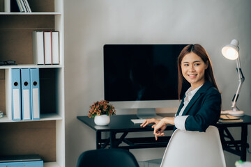 Portrait of Young woman using laptop computer at the office, Student girl working at home. Work or study from home, Asian woman freelance, business, lifestyle concept