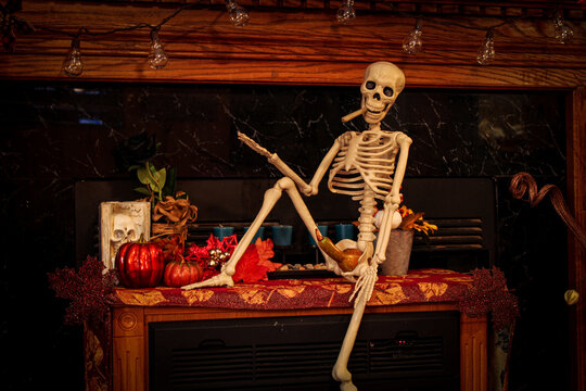 Skeleton getting ready to smoke a joint while sporting a gourd for a boner in his Halloween costume