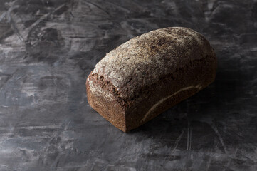 Rye bread on dark board background