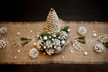 Winter Seasonal celebration. New Year festival. Hand made Christmas tree made from pine cone and spruce branches with linen background.