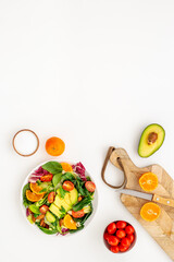 Healthy vegetarian bowl of green salad with avocado and tomatoes