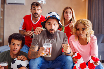 Football fans tense while watching the game on TV