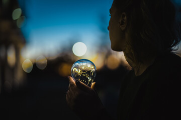 young worried woman holding bright shining lightbulb in her hands feeling unsave while in fear...