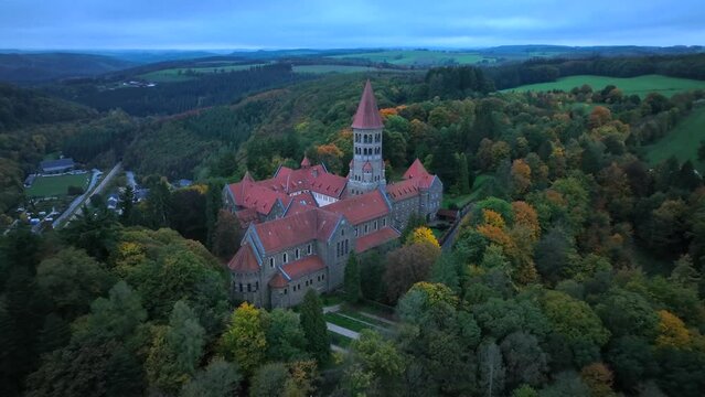 Aerial drone Shot of Abbey in Clervaux, Luxembourg in mystery evening twilight 