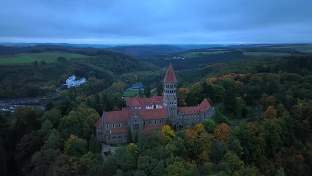 Aerial drone Shot of Abbey in Clervaux, Luxembourg in mystery evening twilight 