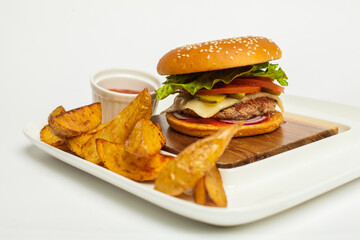 Craft beef burger and french fries on wooden plate  on white background.