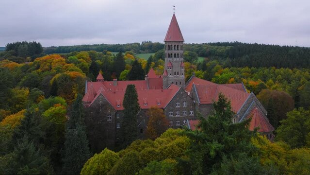 Aerial drone Shot of Abbey in Clervaux, Luxembourg in mystery evening twilight 