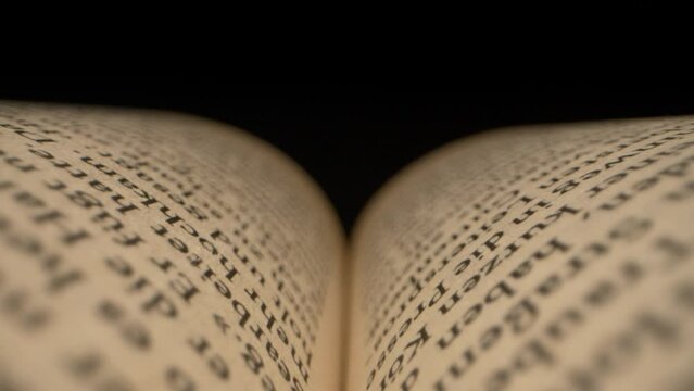 Laowa Probe Lens pulling through the pages of a chapter book.