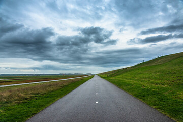 lonely road in the countryside of the netherlands